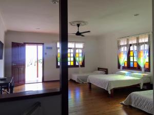 a room with two beds and stained glass windows at MILLBROOK HOUSE TERENGGANU in Kampong Pasir Puteh +8 photos