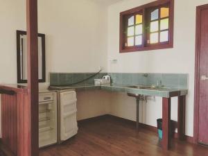 a bathroom with a sink and a mirror on the wall at MILLBROOK HOUSE TERENGGANU in Kampong Pasir Puteh