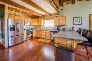 a kitchen with a stainless steel refrigerator and wooden cabinets at Strawberry Fields in Duck Creek Village