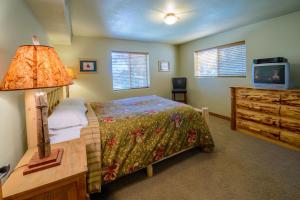 a bedroom with a bed and a dresser and a television at Strawberry Fields in Duck Creek Village