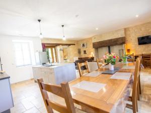 a kitchen and dining room with a wooden table at Maison de Charme avec Jardin, Activités de Plein Air et Proche Sites Touristiques - FR-1-616-333 in Tourtoirac