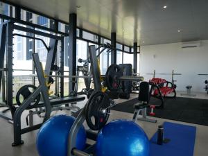 a gym with cardio equipment and blue balls at Meisterstadt Pollux Habibie in Batam Center