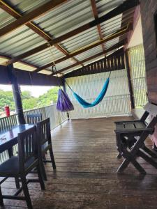 a porch with a hammock hanging from a roof at Tao Thong Villa 2 in Koh Tao