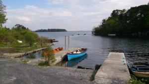 two boats are docked at a dock on a lake at Villa Pio Luxury Apartment 3km from historic Cong, Ashford Castle, Ashford Lodge in Cong