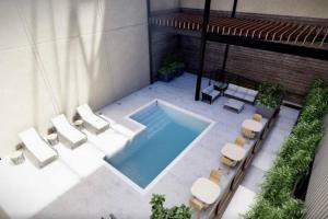 an overhead view of a swimming pool with lounge chairs and a swimming pool at Ballpark Luxury Loft steps from Arch in Saint Louis