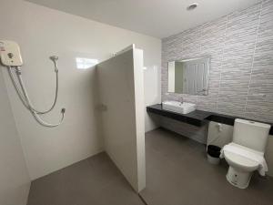 a bathroom with a toilet and a sink at SC Residences in Surat Thani