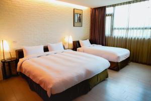Postel nebo postele na pokoji v ubytování 823 Tourist Hotel