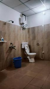 a bathroom with a toilet and a camera on the wall at The Leisure Home Stay in Shādipur