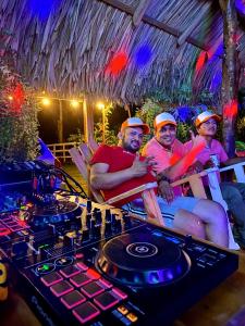 a group of people sitting in chairs in front of a dj table at Finca Dos Apóstoles 
