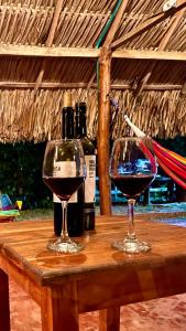 two glasses of wine sitting on a wooden table at Finca Dos Apóstoles 