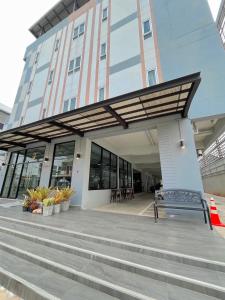 a building with a bench in front of a building at SC Residences in Surat Thani