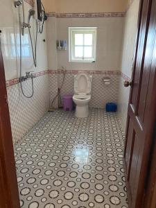 a bathroom with a toilet and a window at villa Nga Hoàng Đà lạt in Da Lat