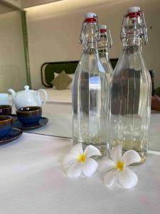 two bottles of water and white flowers on a table at Loving family in Phu Quoc