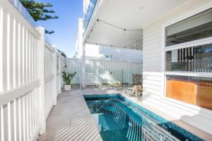 a swimming pool on the side of a house at LegaSea Lodge - Pet Friendly Beachfront with Plunge Pool in Shellharbour