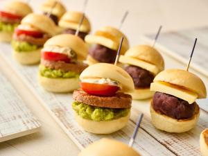 a bunch of mini sandwiches on a tray at Hotel Vischio Kyoto by GRANVIA in Kyoto