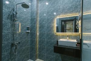 a bathroom with a sink and a shower at Peony Hotel in Can Tho