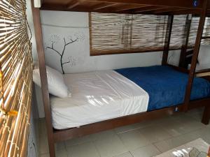 a bedroom with a bunk bed with a blue and white comforter at My Hostel Boracay in Boracay
