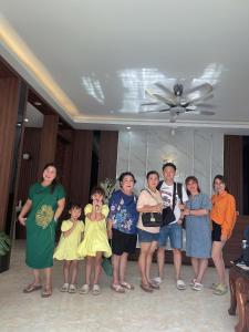 a group of people posing for a picture in a room at Tamcoc Catalina Hotel in Ninh Binh