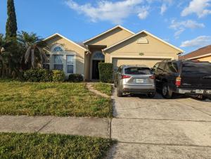 two cars parked in front of a house at 2 private rooms in a quiet neighborhood can book up to 4 people in Orlando