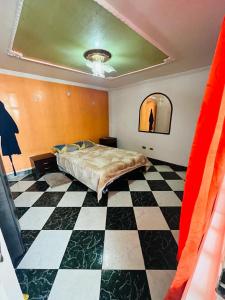 a bedroom with a bed and a checkered floor at Habitación Agradable in Bogotá
