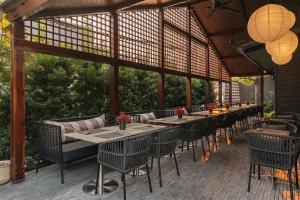 a group of tables and chairs on a patio at Hotel Loy Chiang Mai - Adult Only in Chiang Mai