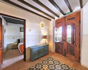 a bedroom with a bed and a wooden door at Casa Rodriguillo in Pinoso