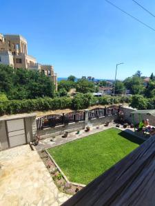 a view of a yard from a balcony at Enjoy Guest House in Golden Sands