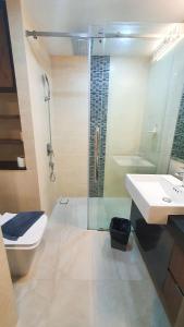 a bathroom with a shower and a toilet and a sink at Mae Phim Holiday Escape Completely in Mae Pim