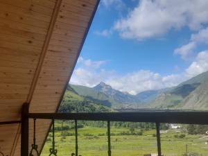 a view of the mountains from the porch of a cabin at Mountain flower cottage in Kazbegi