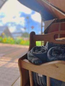 a towel sitting on top of a wooden bench at The Backyard Glamping Cameron Highlands in Tanah Rata