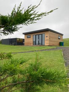 a house on a hill with a green yard at North Coast Escapes in Thrumster