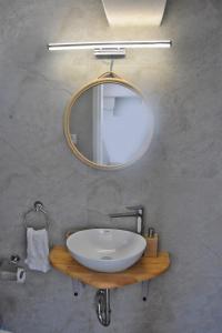a bathroom with a white sink and a mirror at MNS Marvelous Nirvana Seascape, Art in Salamís