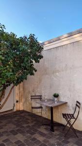 a table and two chairs sitting on a patio at Maison Les 3 oies in Le Crotoy