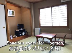a room with a table and a window at Ryokan Ginsuikaku - Vacation STAY 40409 in Maizuru