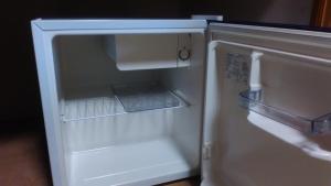 an empty refrigerator with its door open in a kitchen at Ryokan Ginsuikaku - Vacation STAY 40409 in Maizuru