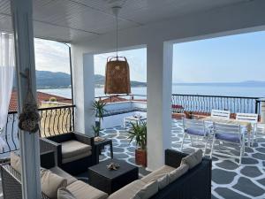 a porch with couches and a view of the ocean at Agape Studios in Neos Marmaras