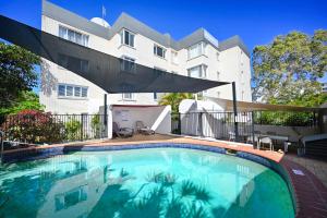 a large swimming pool in front of a building at Spacious 3 Bedroom Delight - Shops & Beaches ZG1 in Caloundra