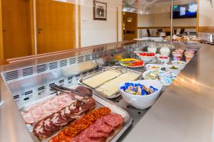 a buffet line with meat and other food items at B&B Pansion Vago in Malinska