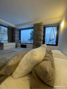 a bedroom with a large bed with a large animal on it at Appart hyper centre Font Romeu in Font-Romeu-Odeillo-Via
