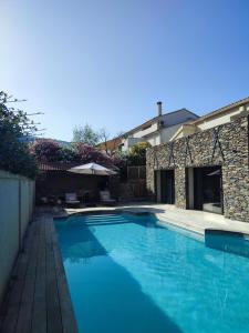 a swimming pool in front of a house at Villa moderne avec piscine privative in Biguglia