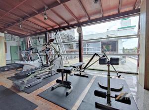 a gym with cardio machines and a large window at Mciti Suites by Evernent in Miri