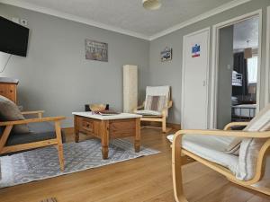 a living room with a bed and a table and a couch at Bermuda Haven 26, Hemsby - Two bed chalet, sleeps 5, pet free site, onsite entertainment in Great Yarmouth