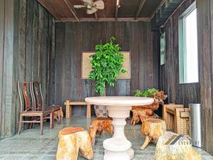 a patio with a table and chairs and a plant at Mciti Suites by Evernent in Miri