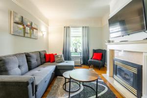 a living room with a couch and a fireplace at Cozy 5 Bedroom House in Downtown Toronto by GLOBALSTAY in Toronto