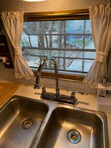 a sink in a kitchen with a window at MAKEX-CAMPER in Tulum