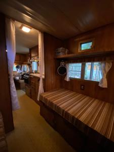 a room with a bed in the middle of a kitchen at MAKEX-CAMPER in Tulum