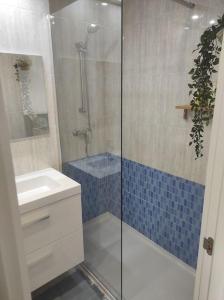 a bathroom with a shower and a sink and a toilet at Apartamento Costa de Madrid in Madrid