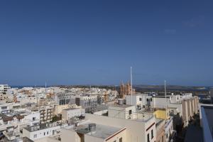 an aerial view of a city with buildings at Victoria by Petit Chic in Mellieħa