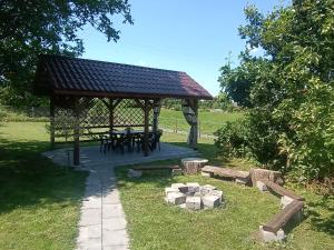 a picnic shelter with a picnic table in a park at Ostoja u Moni in Stare Juchy