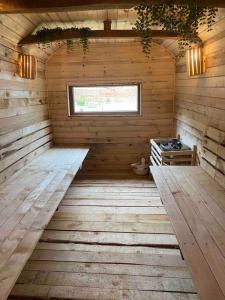 an interior of a wooden cabin with a window at modernes „Tiny House“ in Pleven